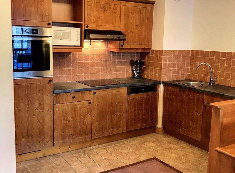 This charming kitchen features warm wooden cabinetry and a cozy atmosphere.