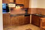 This charming kitchen features warm wooden cabinetry and a cozy atmosphere.