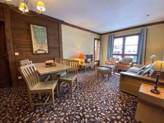 This charming property boasts a cozy living space with a dining area, perfect for relaxing or entertaining.