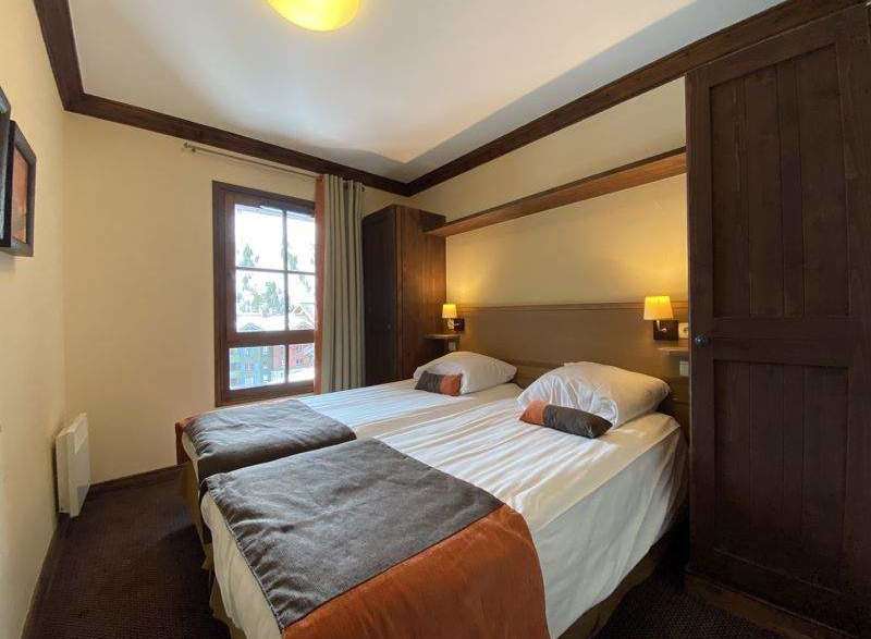 This cozy bedroom features two comfortable beds, perfect for a relaxing stay.