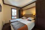 This cozy bedroom features two comfortable beds, perfect for a relaxing stay.