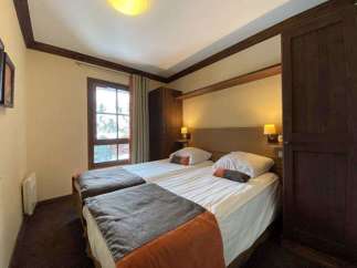 This cozy bedroom features two comfortable beds, perfect for a relaxing stay.