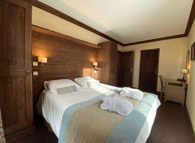 Cozy bedroom with wooden accents and a comfortable bed.
