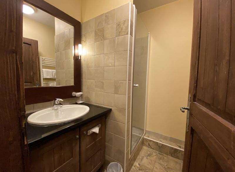 This charming bathroom features a stylish vanity with a sleek countertop and a modern sink.