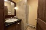 This charming bathroom features a stylish vanity with a sleek countertop and a modern sink.
