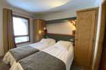 Cozy bedroom featuring two twin beds, perfect for a comfortable stay.