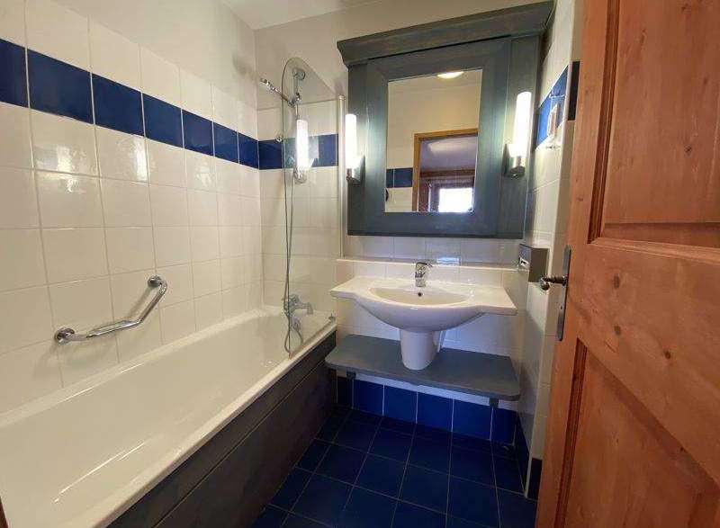 This charming bathroom features a classic design with a bathtub and a sink.
