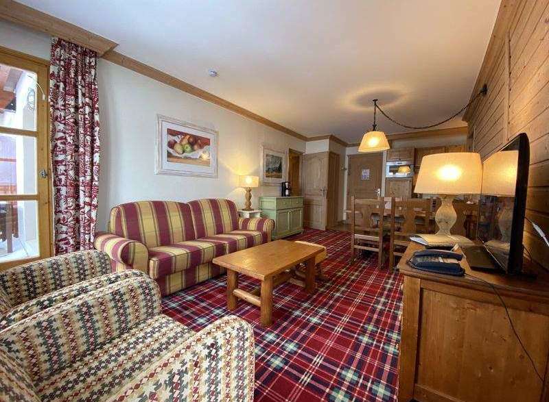 Cozy living space with a striped sofa and patterned armchairs.