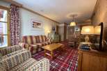 Cozy living space with a striped sofa and patterned armchairs.