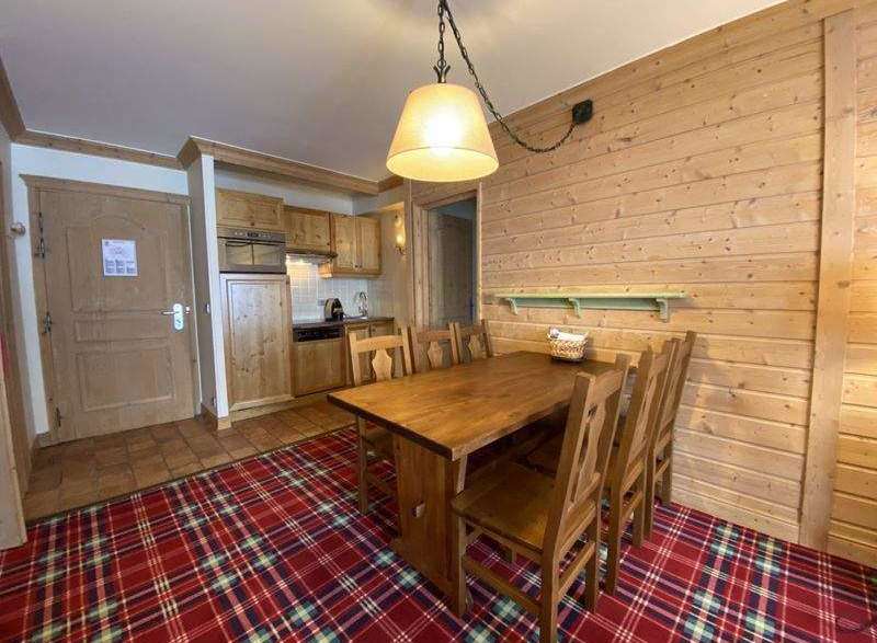 This cozy space features a charming wooden dining table and chairs, perfect for enjoying meals.