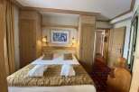 Cozy bedroom with wooden accents and a comfortable bed.