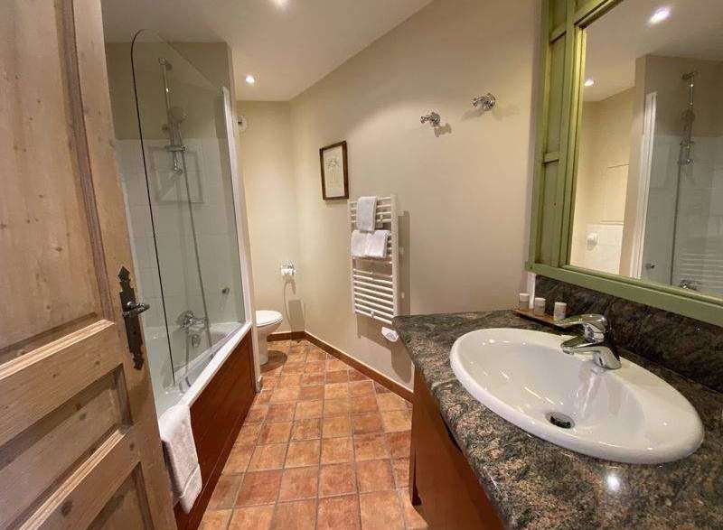 Step into a beautifully designed bathroom, featuring a sleek sink and a spacious shower.