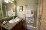 Discover a charming bathroom with a stylish vanity and a sleek sink.
