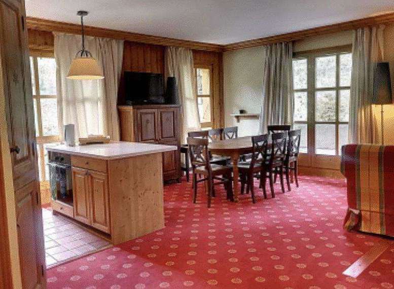 Cozy dining area with a wooden table and chairs, perfect for family gatherings.