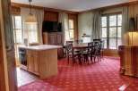Cozy dining area with a wooden table and chairs, perfect for family gatherings.
