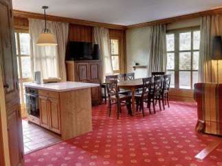 Cozy dining area with a wooden table and chairs, perfect for family gatherings.