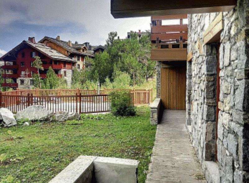 Discover a stunning property with a unique stone facade and a charming wooden balcony.