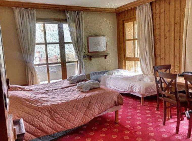 Cozy and inviting, this room features two comfortable beds perfect for a relaxing stay.