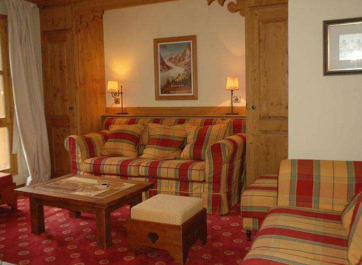 Cozy up in this charming living space! Featuring a comfortable sofa and armchair, perfect for relaxing after a day of exploring.