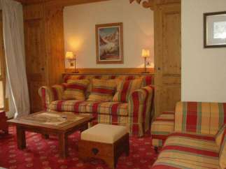 Cozy up in this charming living space! Featuring a comfortable sofa and armchair, perfect for relaxing after a day of exploring.