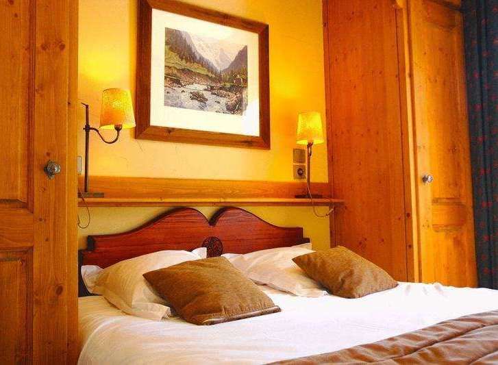 Cozy bedroom with warm lighting and wooden accents.