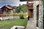 Discover a stunning property with a unique stone facade and a charming wooden balcony.