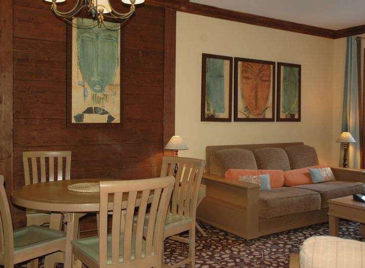 This cozy living space features a charming round dining table and chairs, perfect for intimate gatherings.