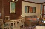 This cozy living space features a charming round dining table and chairs, perfect for intimate gatherings.