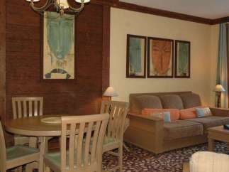 This cozy living space features a charming round dining table and chairs, perfect for intimate gatherings.