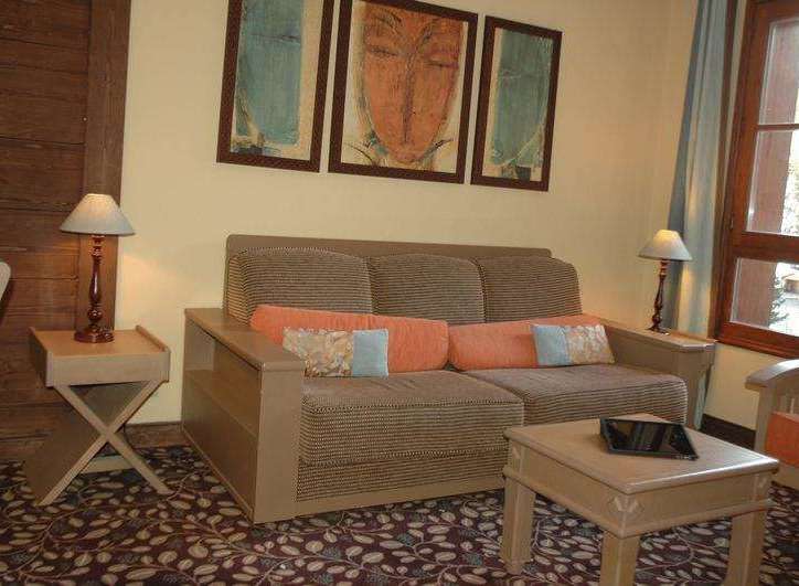 Cozy living space featuring a comfortable sofa adorned with colorful pillows, perfect for relaxation.