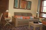 Cozy living space featuring a comfortable sofa adorned with colorful pillows, perfect for relaxation.