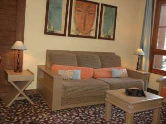 Cozy living space featuring a comfortable sofa adorned with colorful pillows, perfect for relaxation.