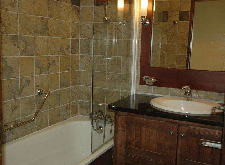 This bathroom features a classic design with warm, earthy tones.