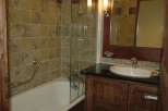 This bathroom features a classic design with warm, earthy tones.