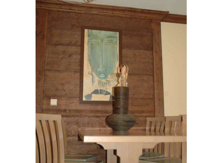 This dining area features a unique wooden wall paneling that adds warmth and character to the space.