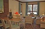 This cozy living space features a dining area with a wooden table and chairs, perfect for enjoying meals.