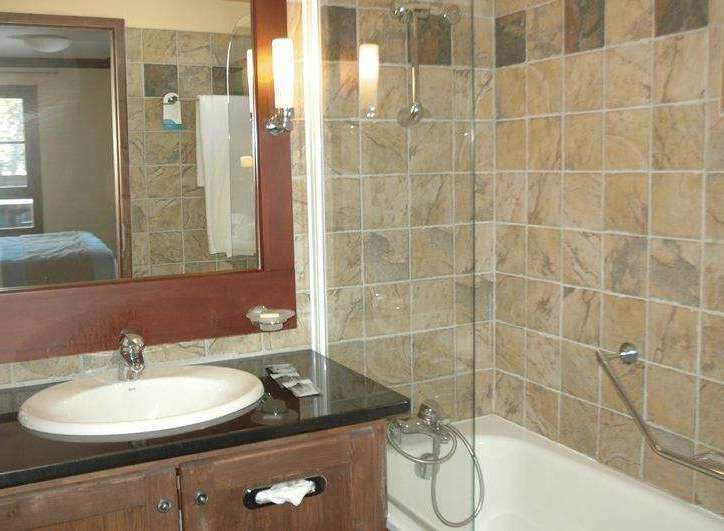 This bathroom features a stylish design with a modern sink and a sleek countertop.