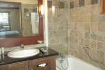 This bathroom features a stylish design with a modern sink and a sleek countertop.