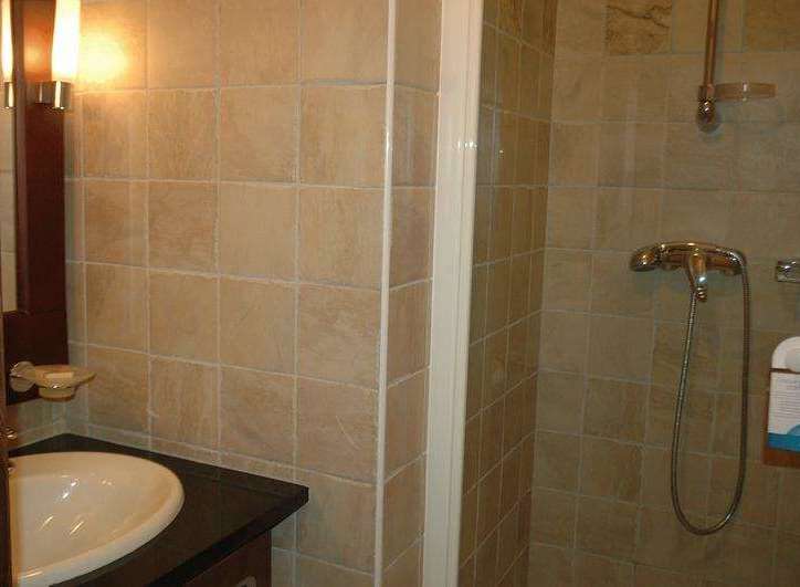 Step into a beautifully tiled bathroom, perfect for a relaxing stay.