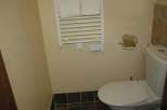 This cozy bathroom features a heated towel rack, perfect for warming up towels.