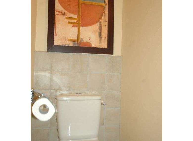This property features a modern bathroom with a stylish toilet.