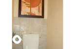 This property features a modern bathroom with a stylish toilet.