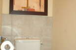 This bathroom features a modern toilet with a convenient toilet paper holder.
