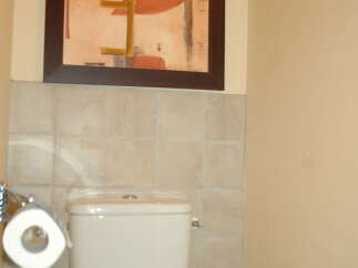 This bathroom features a modern toilet with a convenient toilet paper holder.