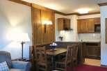 Cozy apartment with a rustic charm, featuring a dining area and a fully equipped kitchen.