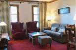 This cozy living space features comfortable seating, including armchairs and a sofa, perfect for relaxation.