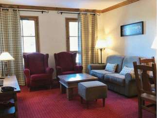 This cozy living space features comfortable seating, including armchairs and a sofa, perfect for relaxation.