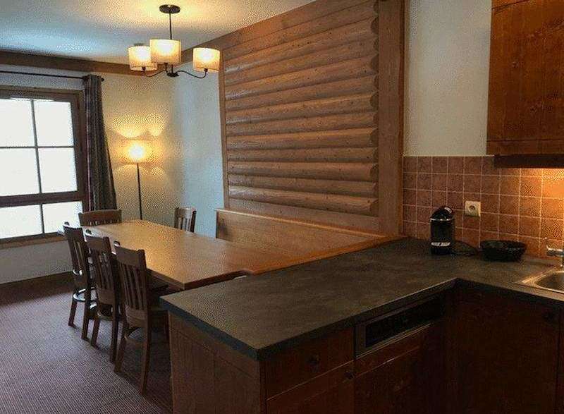 This charming property features a cozy dining area with a rustic wooden table and chairs, perfect for enjoying meals with family and friends.