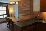 This charming property features a cozy dining area with a rustic wooden table and chairs, perfect for enjoying meals with family and friends.