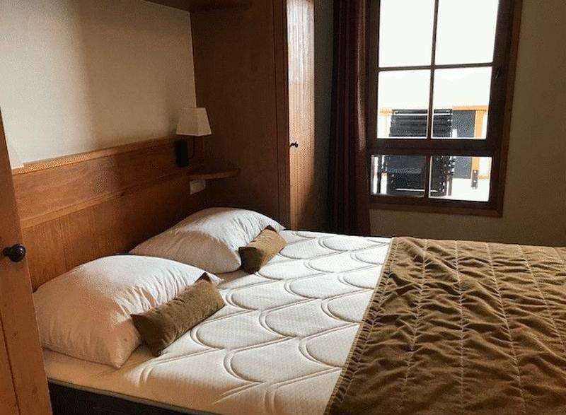 Cozy bedroom with a comfortable bed and soft pillows.